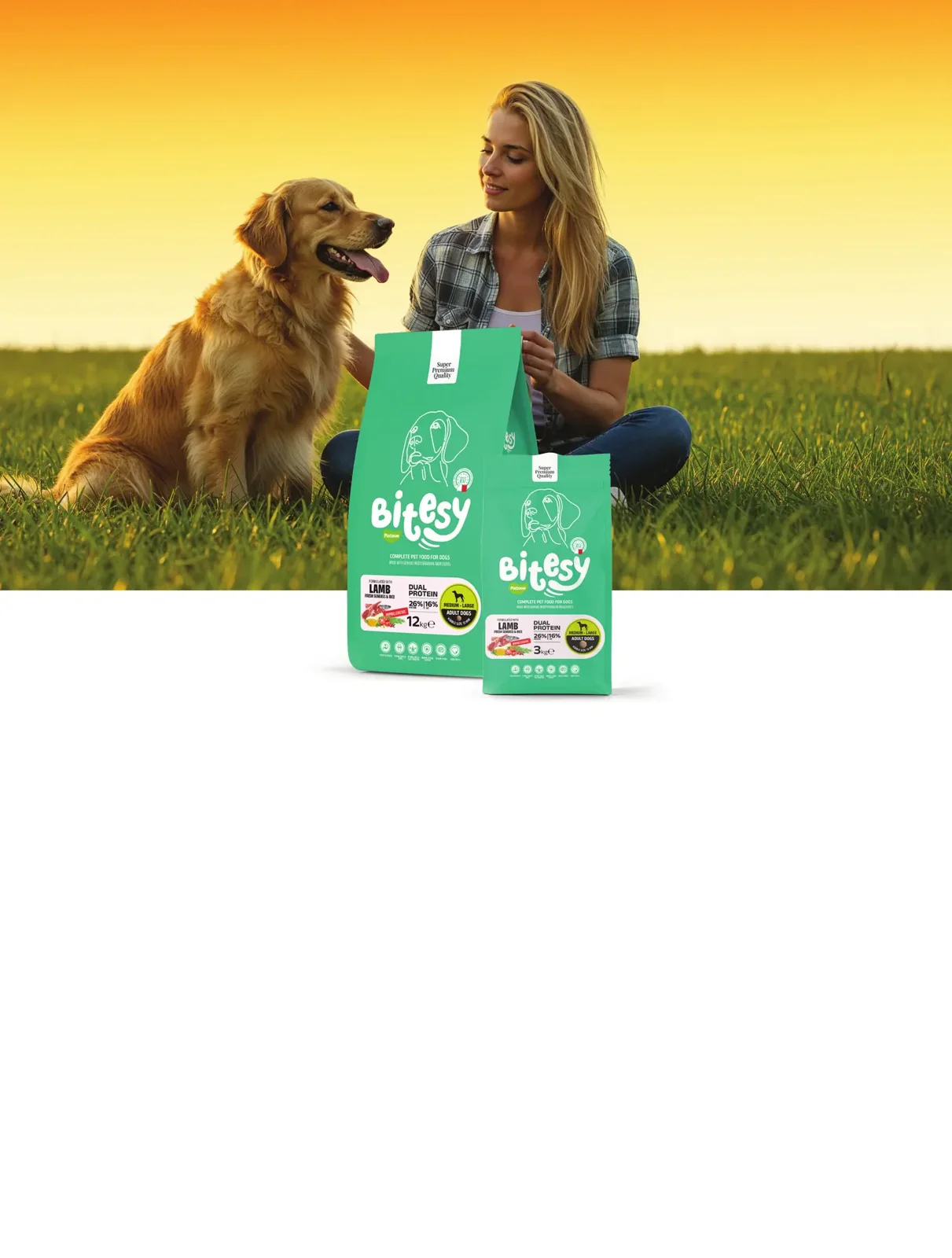 A woman sitting in a field with her golden retriever